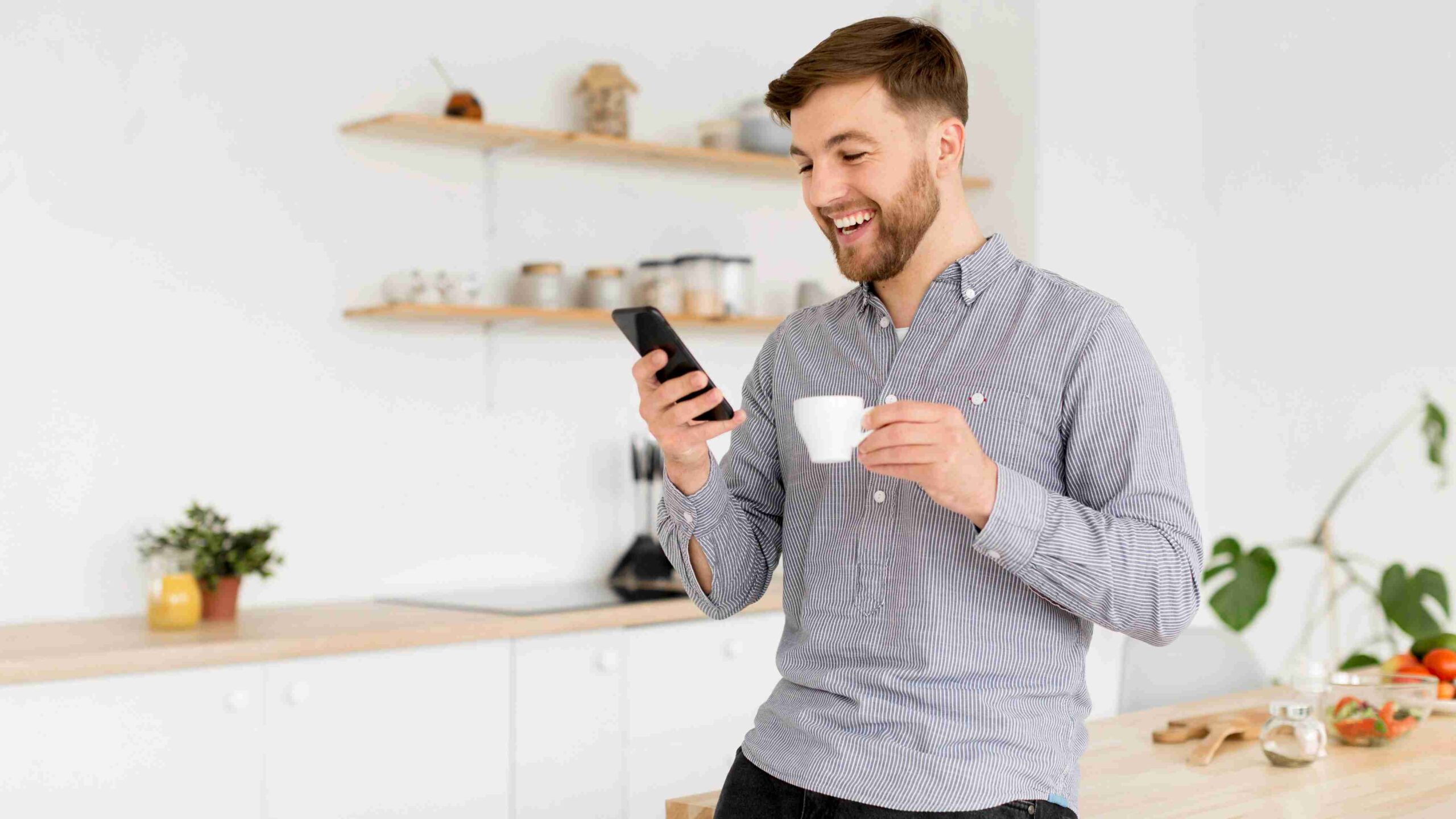 portrait-man-drinking-coffee-while-checking-mobile